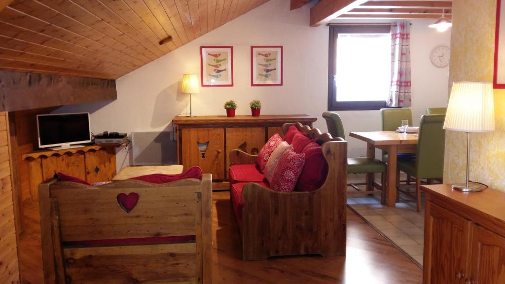 ein Wohnzimmer mit Holzmöbeln und ein Esszimmer in der Unterkunft Lou Veno in Les Deux Alpes