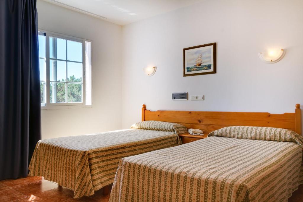 A bed or beds in a room at Duerming San Vicente Hotel