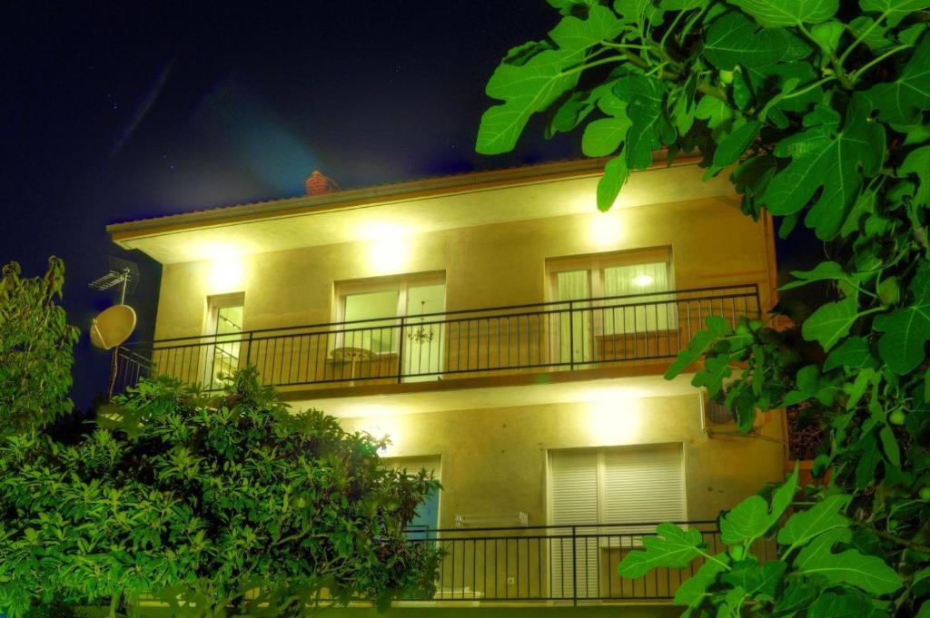 a yellow building with lights on it at night at Apartment Crikvenica 19 in Crikvenica