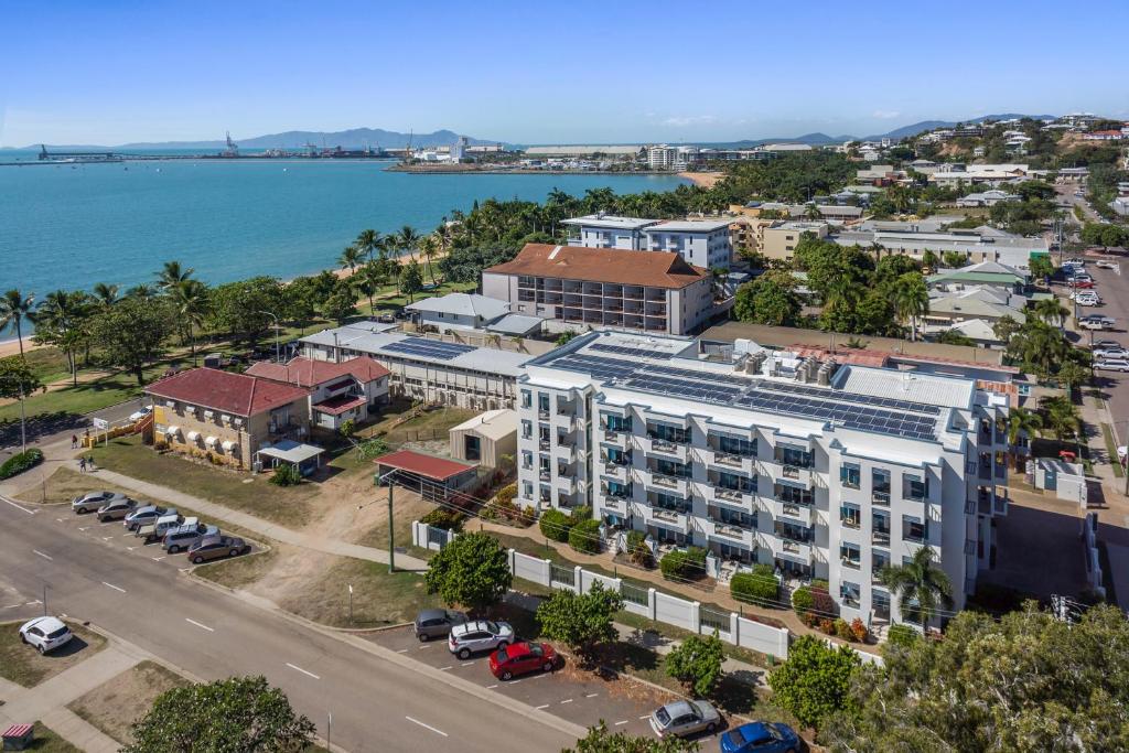 an aerial view of a building with the ocean in the background at Madison Ocean Breeze Apartments in Townsville