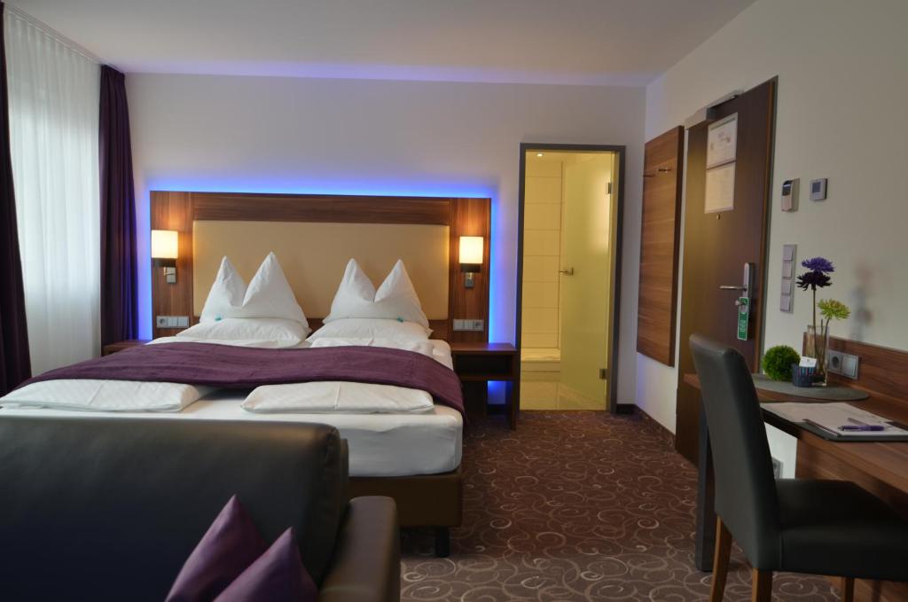Postel nebo postele na pokoji v ubytování Wohlfühl-Hotel Neu Heidelberg
