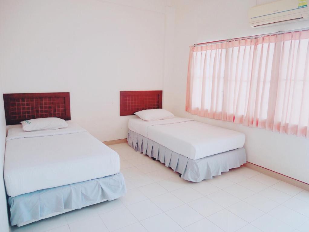 Tempat tidur dalam kamar di Pakchong Phubade Hotel