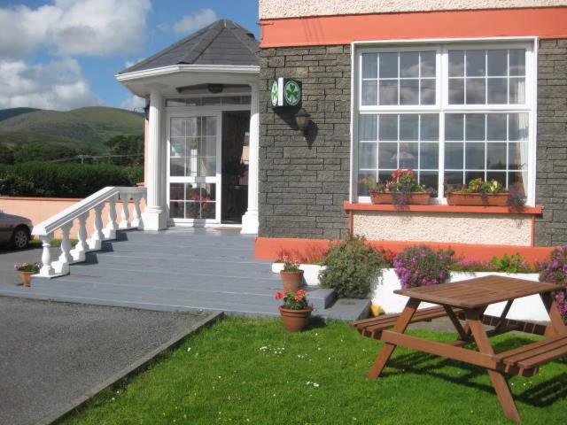 a house with a picnic table in front of it at Alpine Guesthouse in Dingle