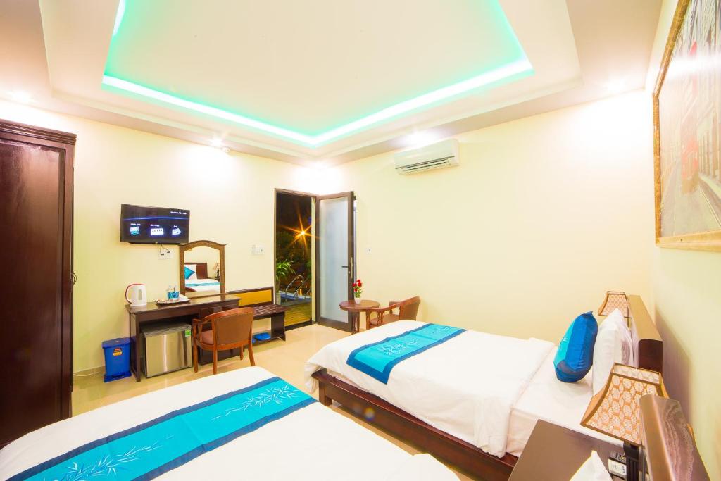 Postel nebo postele na pokoji v ubytování Hào Anh Villa Hội An