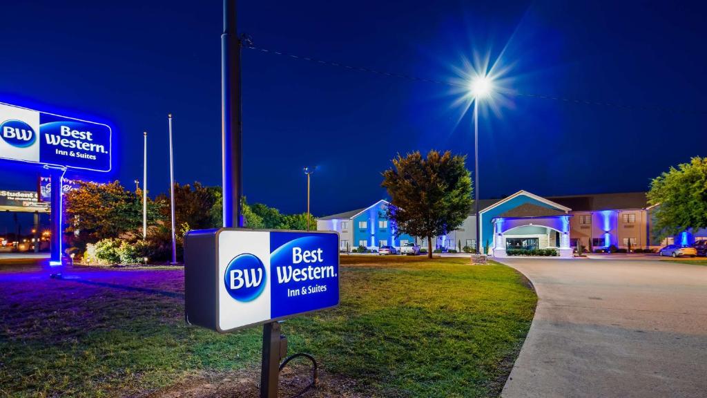 a best western sign in front of a best western building at Best Western Atoka Inn & Suites in Atoka