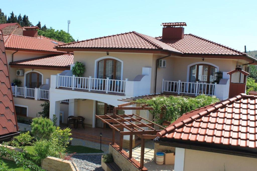 a white house with a red roof at Villa Marmaris in Rybachye