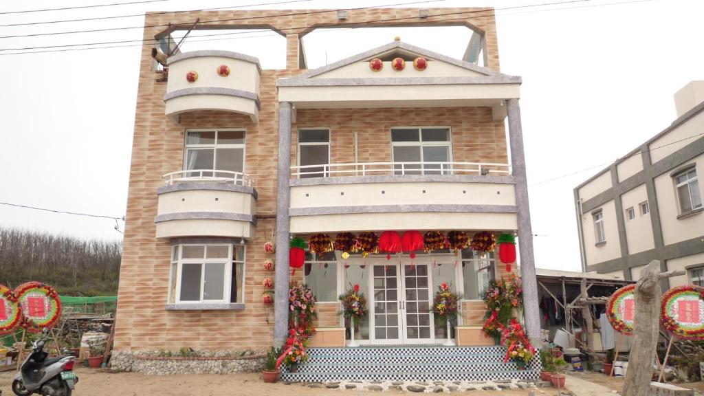 a house with christmas decorations on the front of it at See Starsea Guest House in Magong