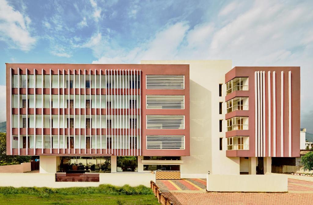 a large building with red and white at Rama Trident, Katra in Katra