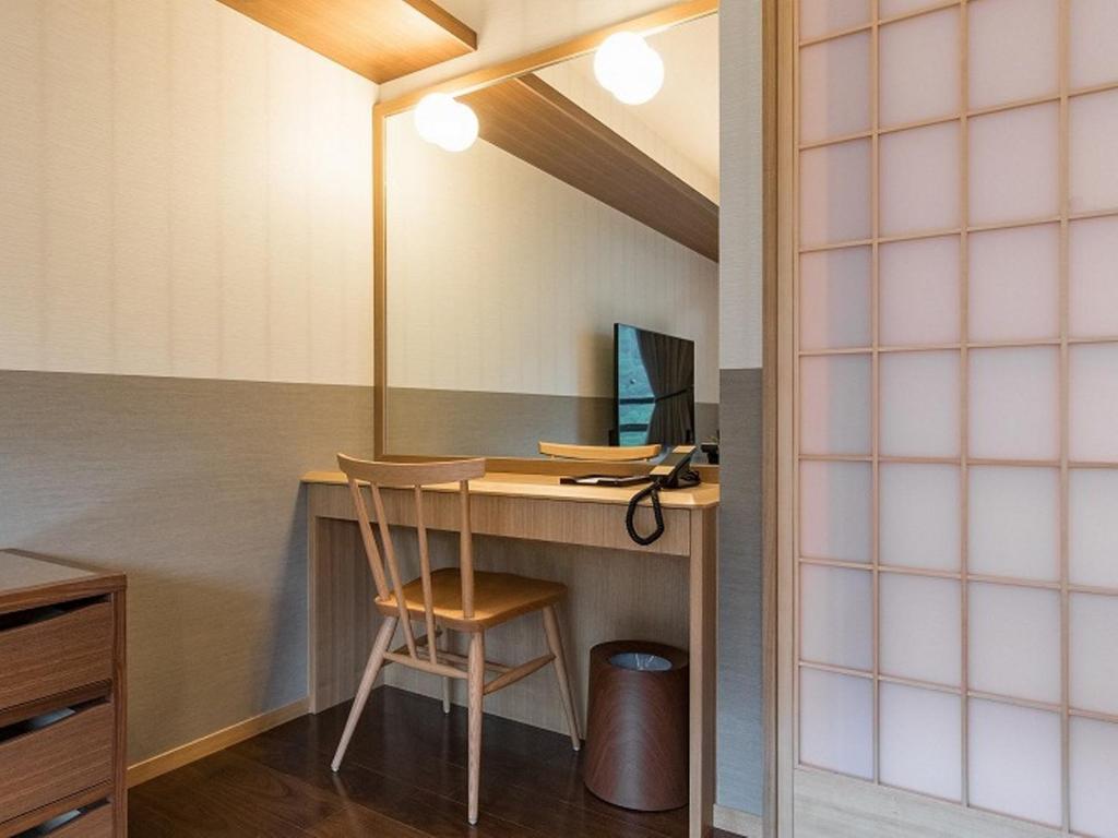 TV a/nebo společenská místnost v ubytování Okuhita Onsen Umehibiki