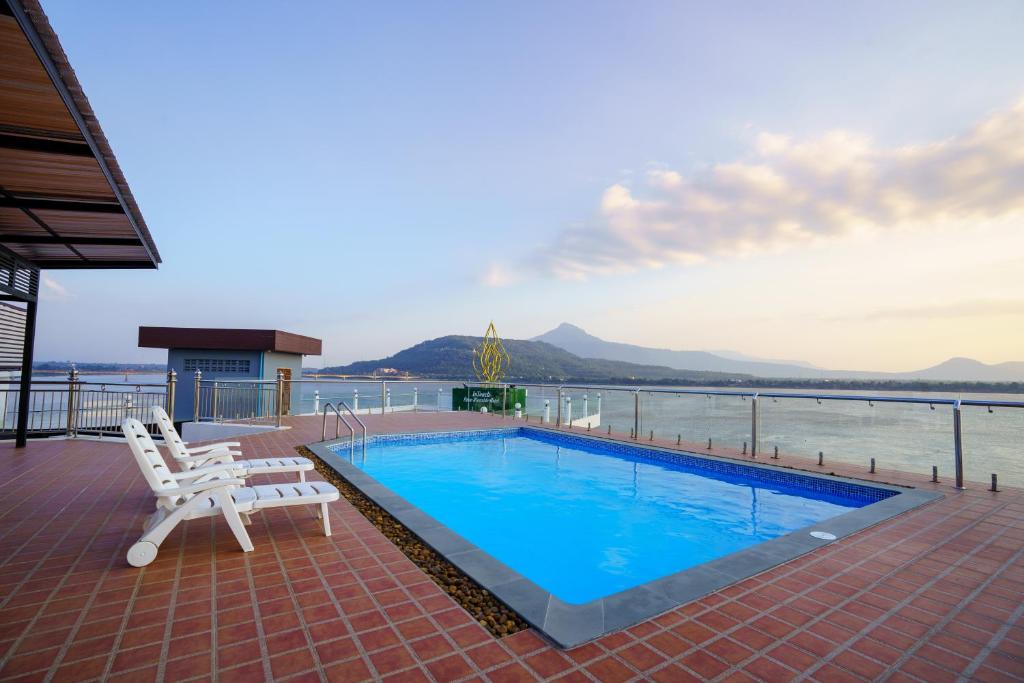 a swimming pool on the deck of a cruise ship at Intouch Riverside Hotel in Pakse