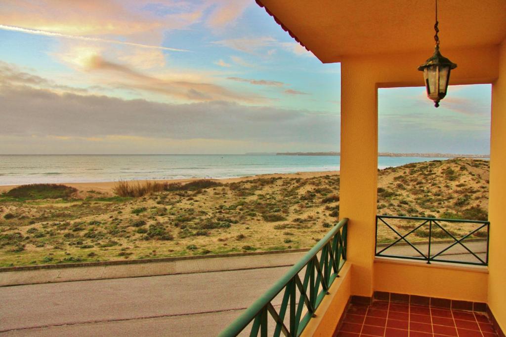 a balcony with a view of the beach at Supertubos Beach Hostel in Peniche