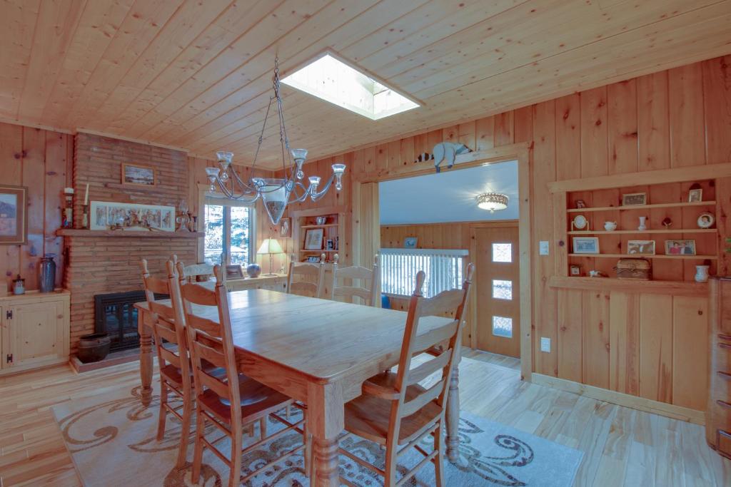 a dining room with a wooden table and chairs at Mountain Haven Plus Loft in Raymond