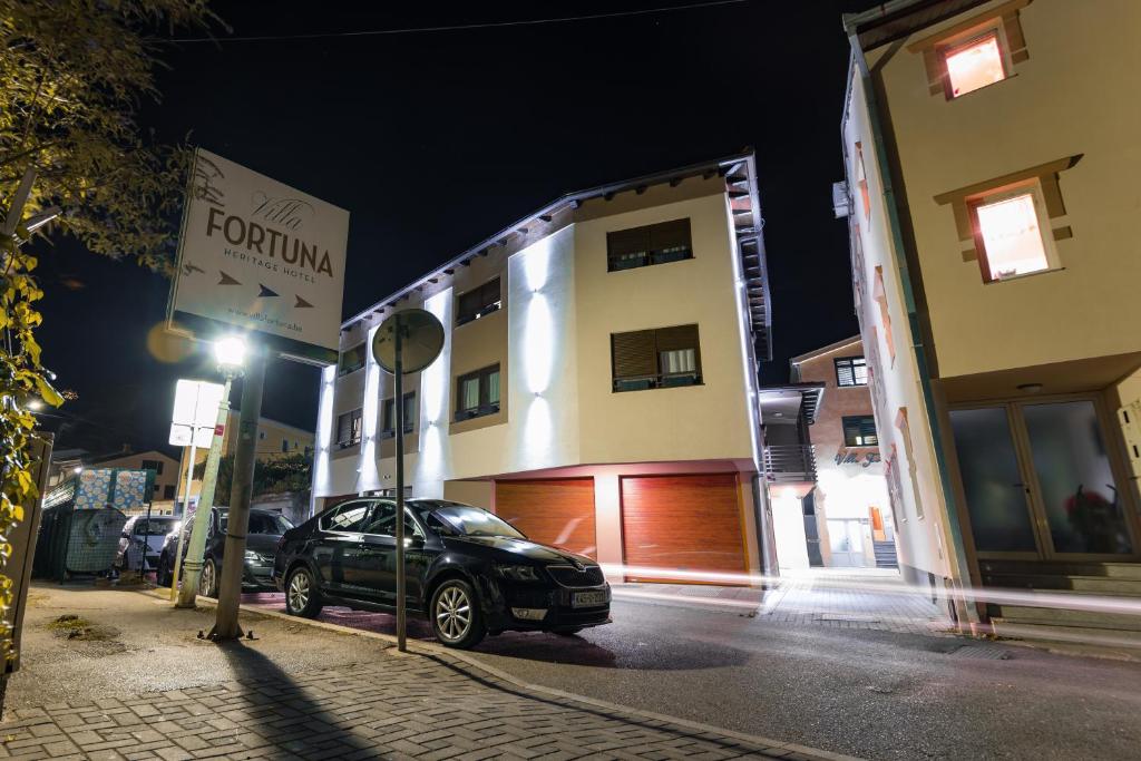 a car parked in front of a building at night at Villa Fortuna in Mostar