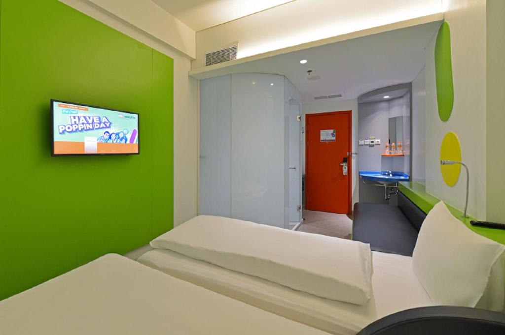 Postel nebo postele na pokoji v ubytování POP! Hotel Solo