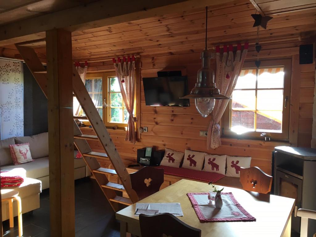 a living room with a table and a dining room at Beerenhütte in Kurort Oberwiesenthal