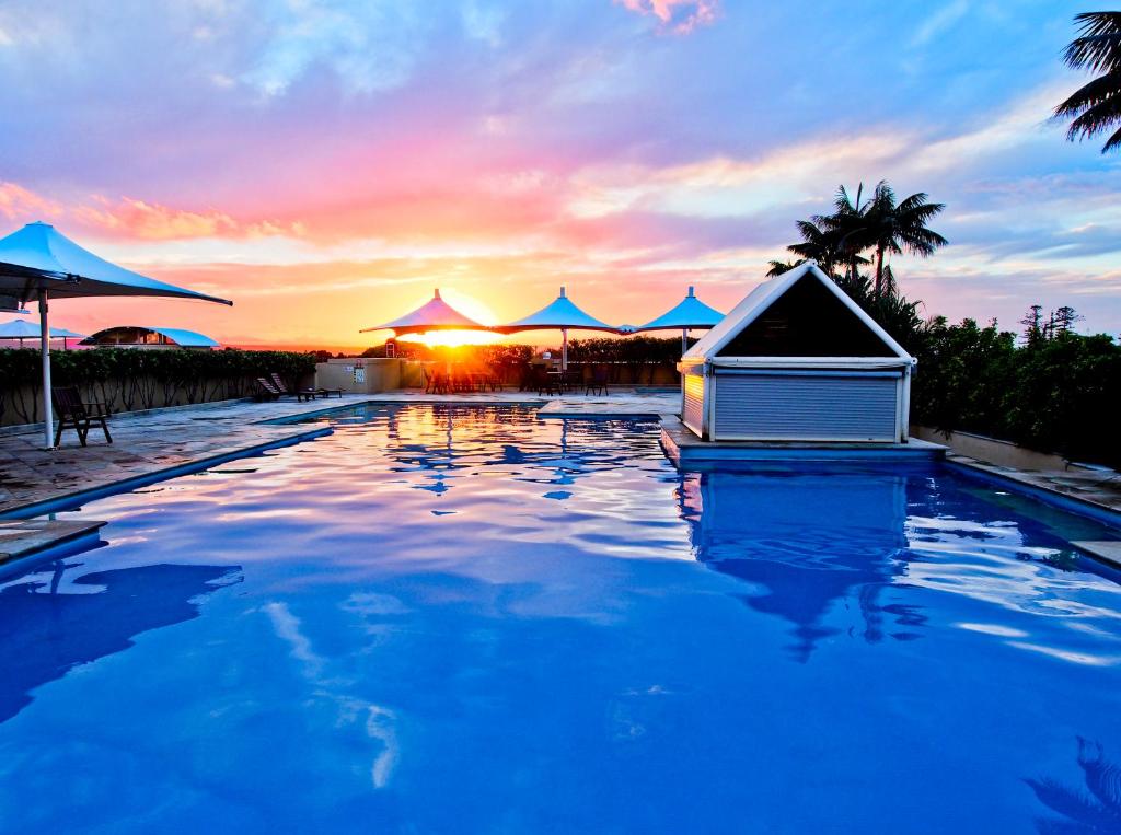 a swimming pool with a house in the middle of it at Oaks The Entrance Waterfront Suites in The Entrance