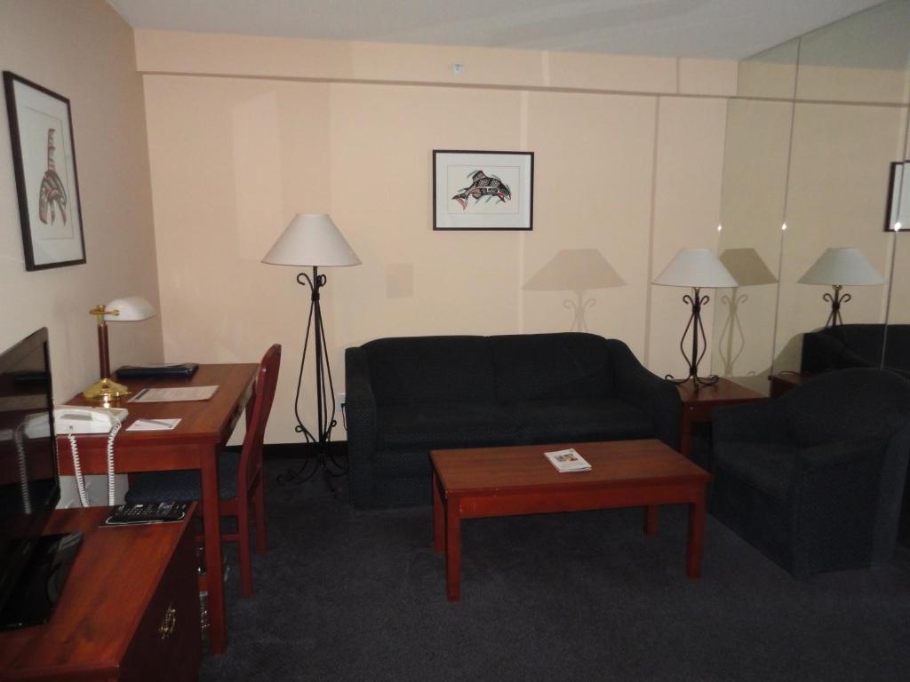 a living room with a couch and a table at Rosedale on Robson Suite Hotel in Vancouver