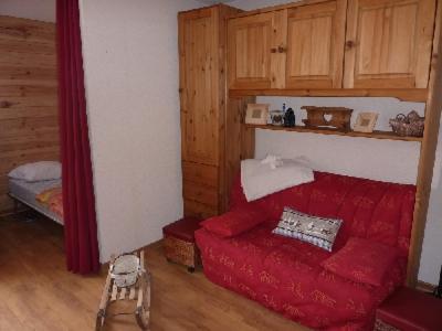 - un salon avec un canapé rouge et un lit dans l'établissement La Combe Blanche 1307, à Manigod