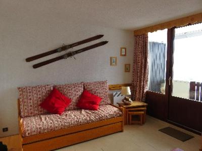 a living room with a couch with red pillows at LE Hameau 001 in Manigod