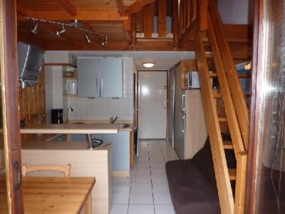 a kitchen with a staircase leading up to a room at Mont Blanc Soleil E17 in Manigod