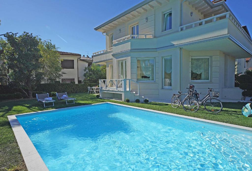 a house with a swimming pool in front of a house at Villa Sabine: New Modern villa with Private pool in Toscolano Maderno