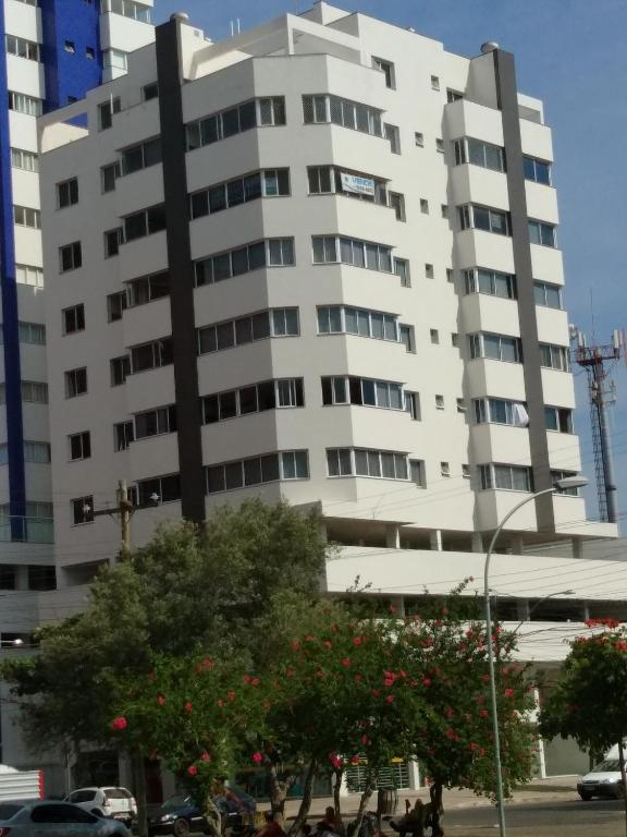 a large white building with trees in front of it at Sonatta in Torres