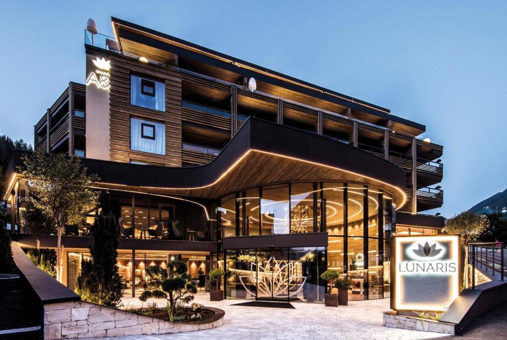 a building with a sign in front of it at LUNARIS Wellnessresort in Cadipietra