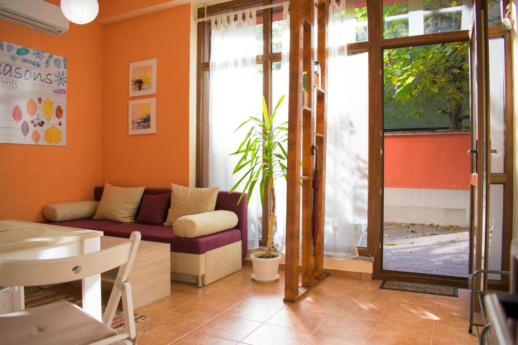 a living room with a couch and a table at 4 Seasons apartments, A1 in Plovdiv