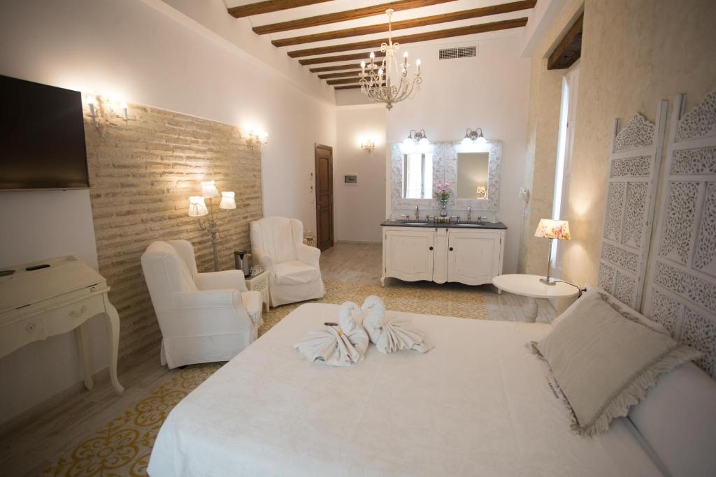 a large white room with a bed and a bathroom at Hotel Argantonio in Cádiz