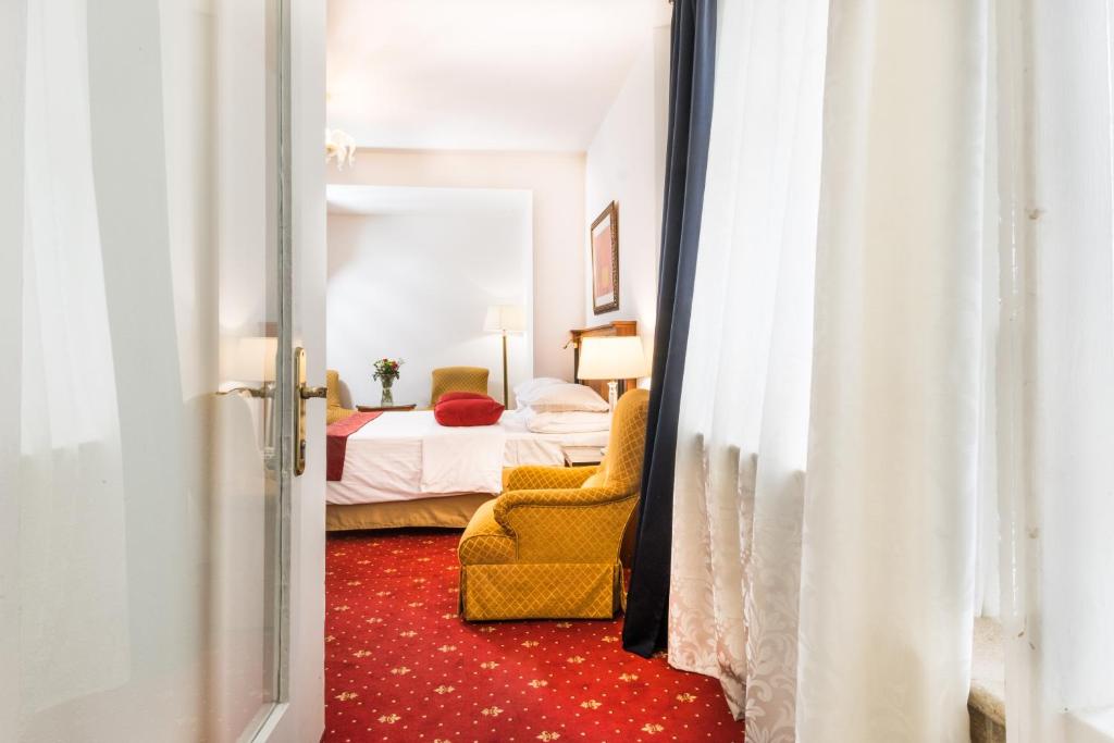 Postel nebo postele na pokoji v ubytování Hotel Leon D´Oro