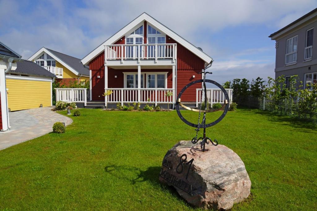 a house with a yard with a rock with a basketball hoop at Thor's Schleilounge in Olpenitz