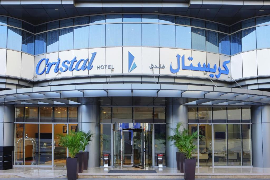 a building with a sign on the side of it at Cristal Hotel Abu Dhabi in Abu Dhabi