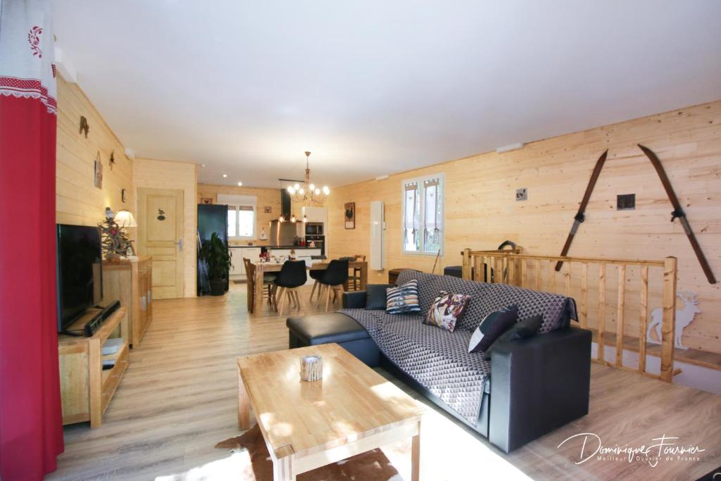 a living room with a couch and a table at au moulin in Esbareich