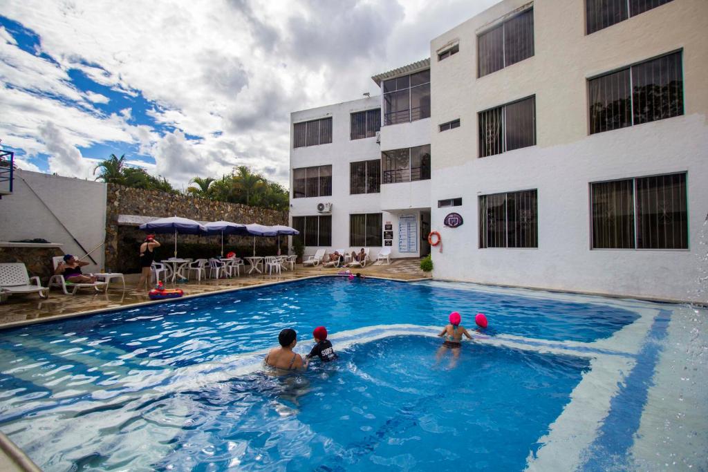 a group of people in a swimming pool at a hotel at Blue Star Hotel in Melgar