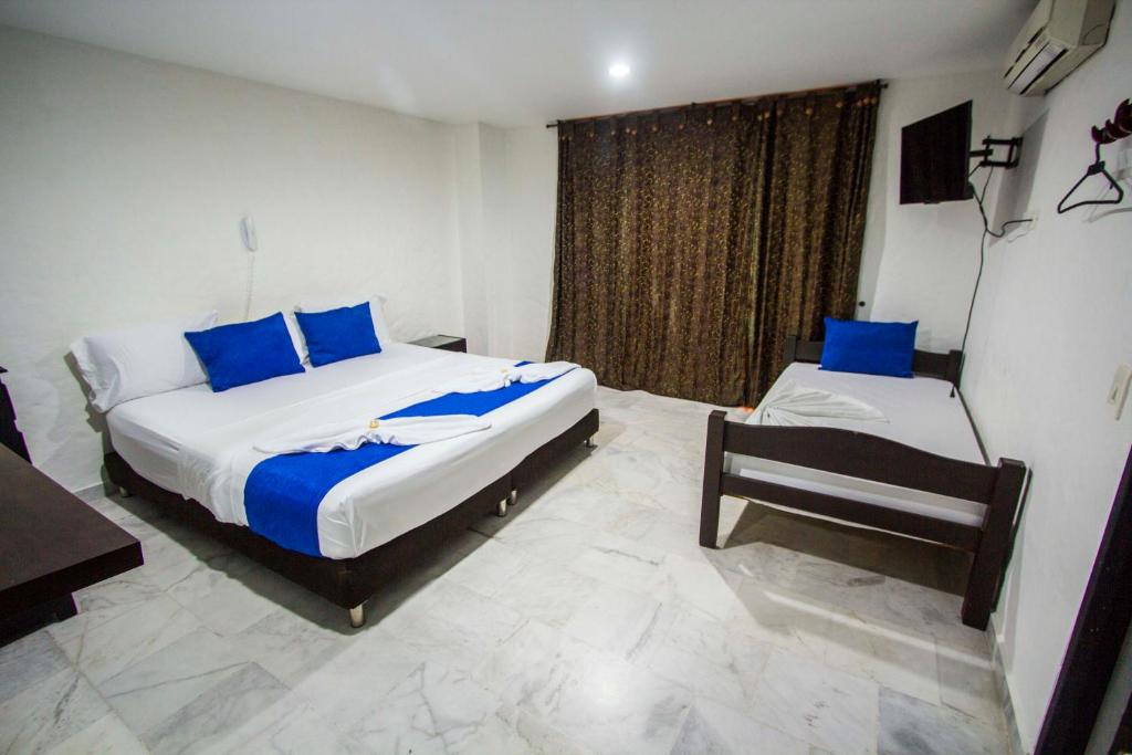 Postel nebo postele na pokoji v ubytování Blue Star Hotel