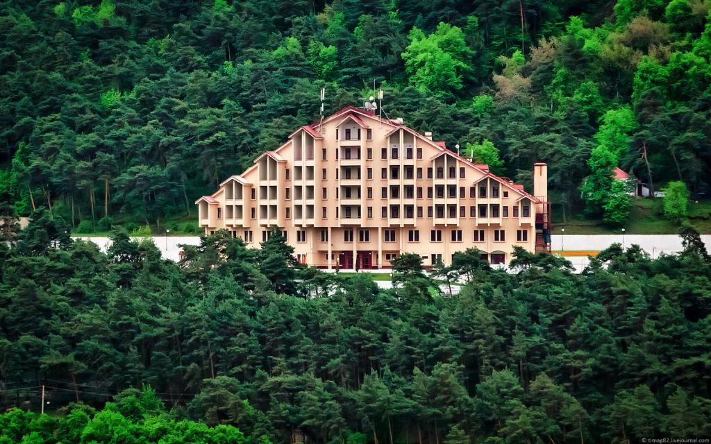 a large building on the side of a mountain at Armkhi Hotel Ingushetia - Все включено in Armkhi