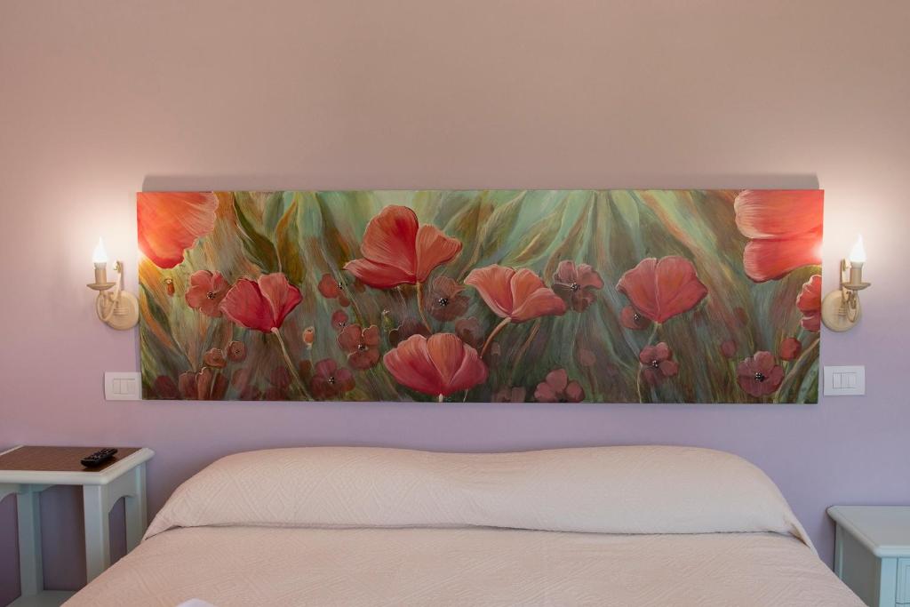 Postel nebo postele na pokoji v ubytování Podere Abbazia b&b