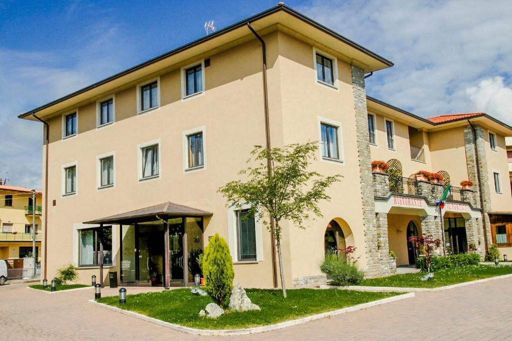 a large building with a tree in front of it at Hotel Santo Stefano in Pieve Santo Stefano