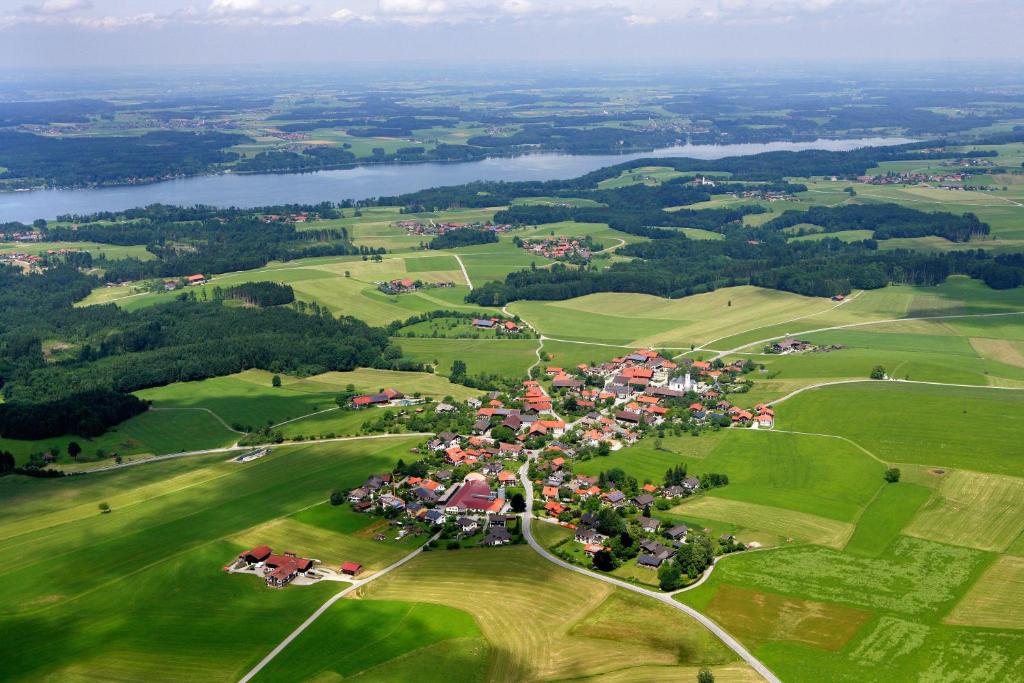 a village in the middle of a green field at Ferienwohnungen Wagenstaller in Söllhuben