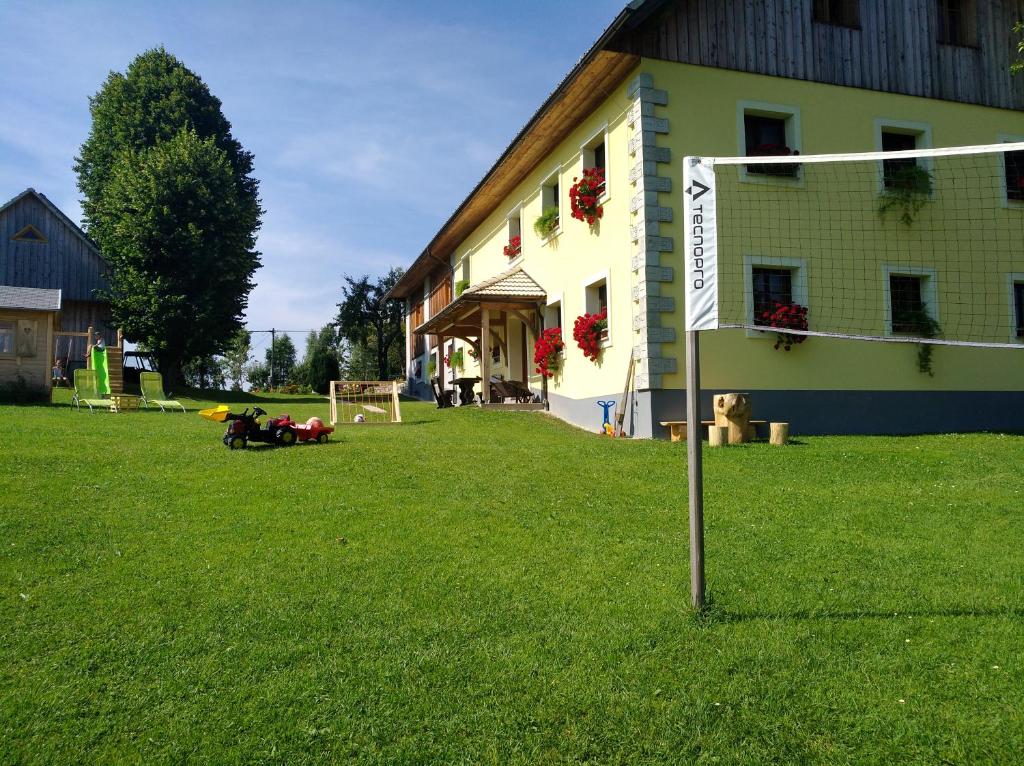 a building with a soccer field in front of it at Apartments Čumar in Cerkno