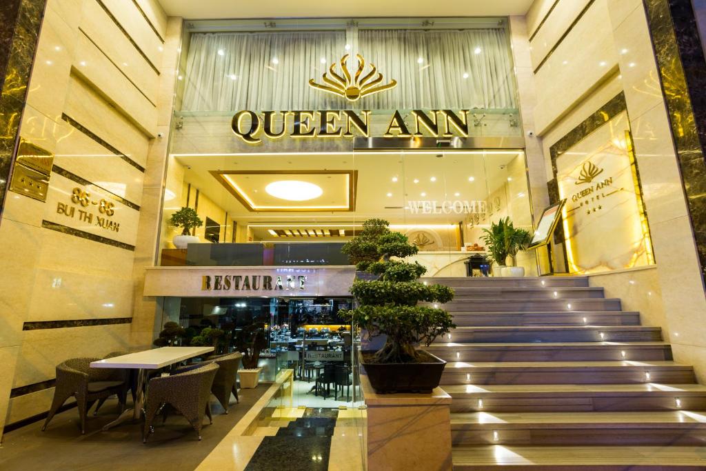 a shopping mall with a staircase leading to a store at Queen Ann Hotel in Ho Chi Minh City