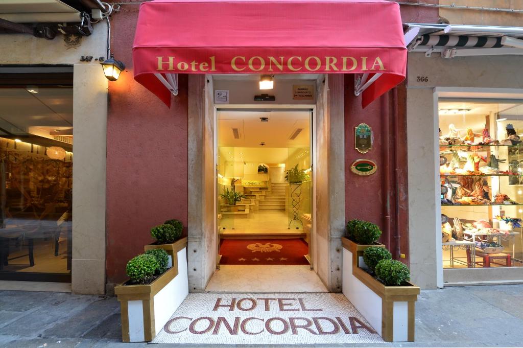 a hotel concordia with a red awning outside of a store at Hotel Concordia in Venice