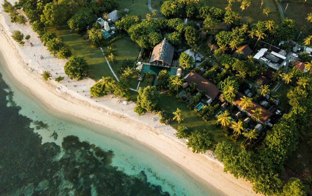 an aerial view of a resort on the beach at Hotel Tugu Lombok - CHSE Certified in Tanjung