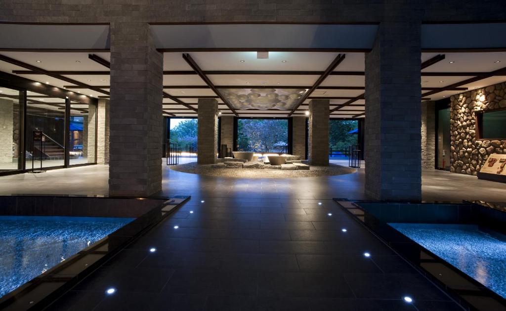 a lobby of a resort with two water fountains at Lake Shikotsu Tsuruga Resort Spa Mizu no Uta in Chitose