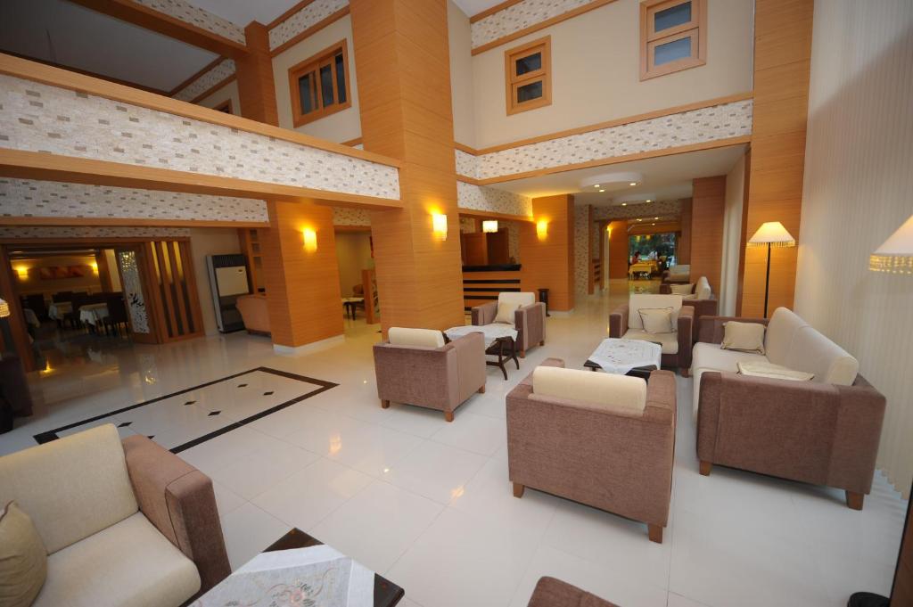a large living room with couches and chairs in a building at Suite Laguna Otel in Antalya