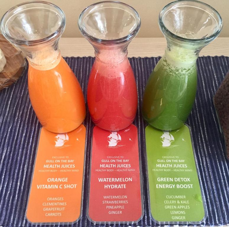three different colored vases sitting on a tray at Gull on the Bay Boutique Guest House in Bloubergstrand