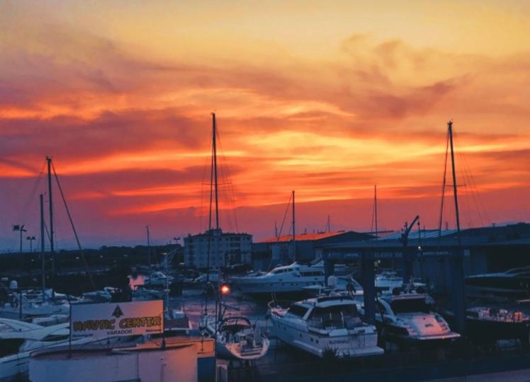 a group of boats parked in a marina at sunset at 22B puigmal D in Empuriabrava