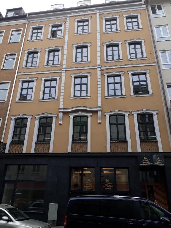 a yellow building with windows on the side of it at Royal Boardinghouse GmbH - Munich in Munich