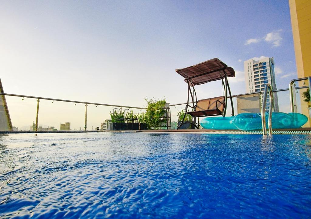 a swimming pool with a water slide and a playground at Phuong Tran Apartment and Hotel in Danang