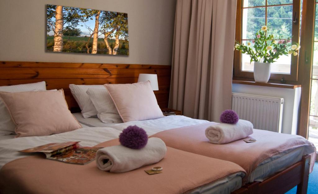 a hotel room with two beds with towels on them at Hotel Górski Czarna Góra in Stronie Śląskie